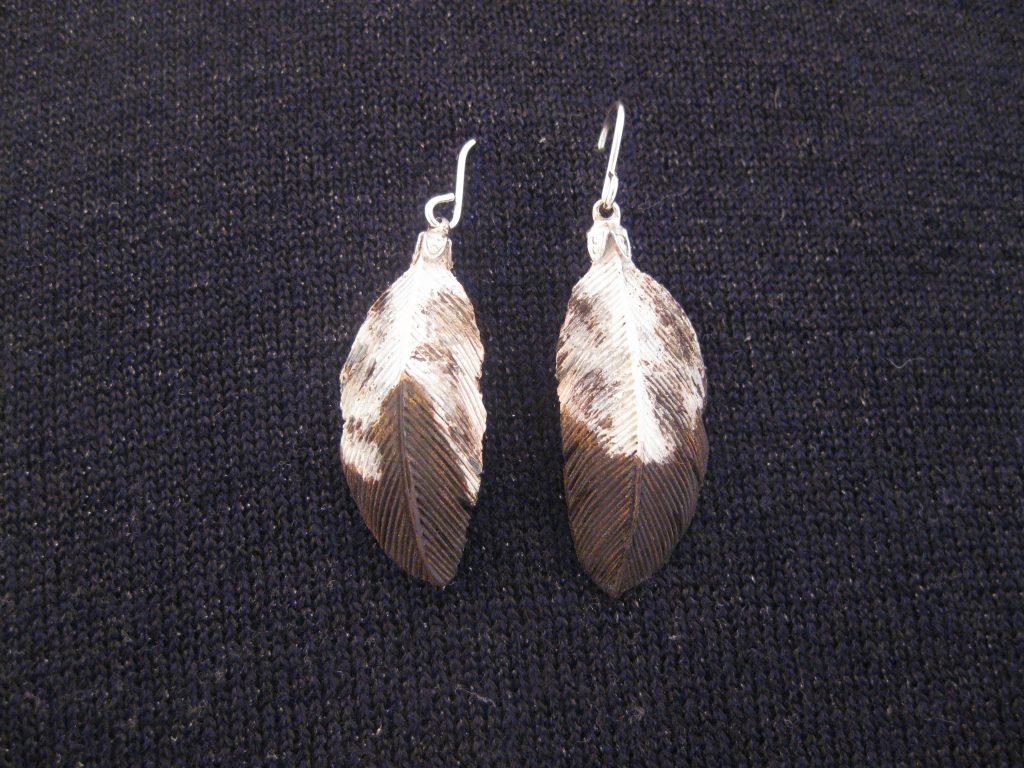 Juvenile Golden Eagle hand carved original Tupelo Feather Earrings. Each earring is a one-of-a-kind hand carved original hand painted in acrylics with Sterling Silver Wires